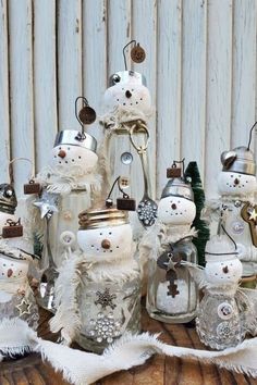 a group of snowmen sitting next to each other on top of a wooden table