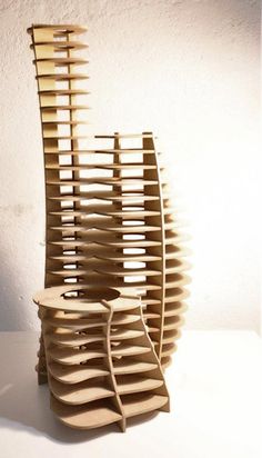 a wooden sculpture sitting on top of a white table