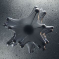 an object is shown in the air with water droplets and bubbles on it's surface