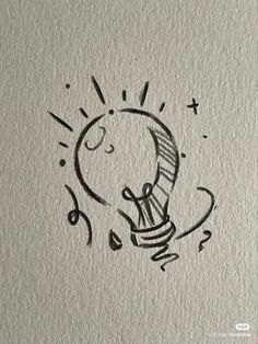 a drawing of a light bulb on paper