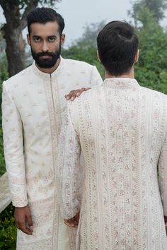 White sherwani with embroidery and sequin work. Comes with off white kurta, pants and juttis.
Components:4
Pattern:Embroidery
Type of Work:Thread Embroidery and Sequin
Neckline:Band
Sleeve Length:Full
Fabric:Bhagalpuri Silk and Cotton Silk
Color:White
Other Details:
Side slits
Side pockets
Closure: Hook front
Note: The off white sherwani set worn by the other model is not for sale
Occasion:Wedding - Aza Fashions White Thread Embroidery, White Sherwani, Kurta Pants, Kurta Set For Men, White Kurta, Pattern Embroidery, Cotton Embroidery, Thread Embroidery, Fashion App