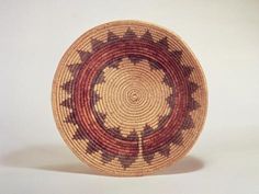 a brown and red basket sitting on top of a table