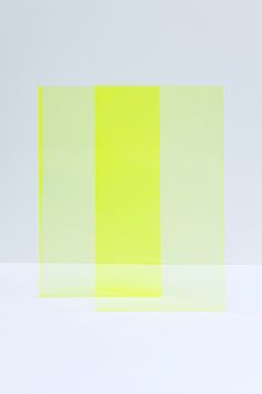 an abstract painting with yellow and green squares on it's sides, against a white background