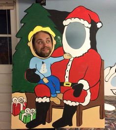 a man sitting in front of a christmas painting