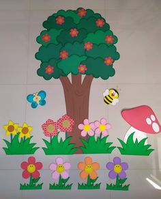 this is an image of a wall with flowers and a tree in the middle that has a bee on it