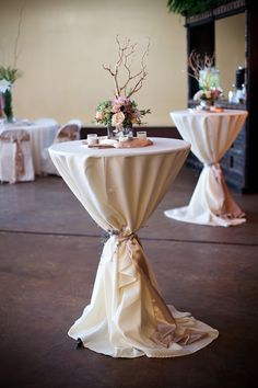 an image of a table setting for a wedding reception with white linens and flowers