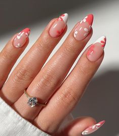 a woman's hand with pink and white nail polish