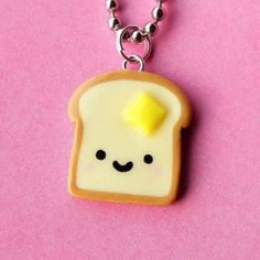 a piece of bread with a smiley face on it is hanging from a ball chain