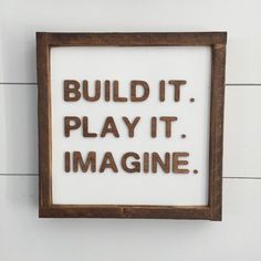 the words build it, play it, imagine are spelled in brown letters on a white background