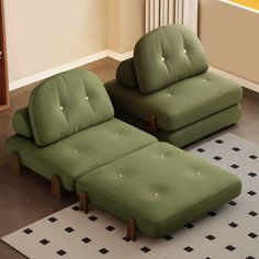 two green couches sitting on top of a rug