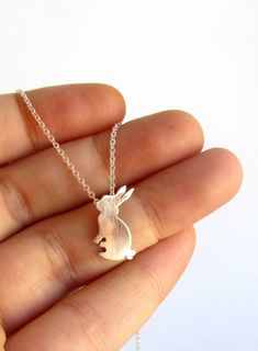 A cute handmade little rabbit necklace for bunny lovers or to remember a loving pet. Handmade with High quality Sterling silver and Sterling silver chain. - This is a perfect gift for pet and bunny lovers or a special gift to remember the memories shared with a loving pet. - The necklace in the pictures is 16'' size. - Available in sizes 15'' to 30''. - CHECK YOUR SIZE measuring your neck with a string or yarn. - Your necklace arrives beautifully packaged and is ready to gift. - One necklace. MA Cute Handmade Sterling Silver Necklaces, Cute Charm Necklaces For Gifts, Easter Bunny Design Jewelry Gift, Cute Round Pendant Charm Necklaces As Gifts, Cute Round Pendant Charm Necklace For Gifts, Cute Round Pendant Charm Necklaces For Gifts, Cute Handmade Easter Jewelry, Cute Hypoallergenic Charm Necklaces For Gifts, Cute Hypoallergenic Charm Necklace For Gift