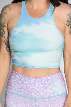 The Teeki Mermaid Tanks are cut with a high neckline and razor back crop top. They can be layered and offer gentle compression for low-impact workouts, yoga, swimming, and everyday layering. Fit: The single layer of lightweight fabric offers a gentle compression for low impact activities and daily use. Move freely in yoga class, by the pool, in the ocean, or layering without the discomfort of tight elastic bands, thick materials and underwires. If you have a small chest size the fit may not be t We Love The Earth, Mermaid Tank, The Perfect Workout, Yoga Crop Tops, Womens Yoga, Recycled Water Bottles, Perfect Workout, Love The Earth, Eco Friendly Clothing