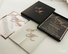 the wedding stationery is black and white with rose gold lettering on it, along with matching envelopes