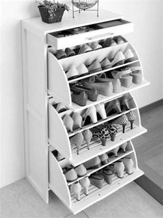 a white shoe rack sitting next to a wall