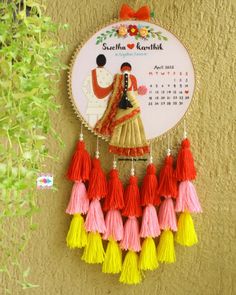 a calendar hanging on the wall with tassels