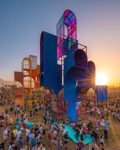 a large group of people standing in front of colorful structures