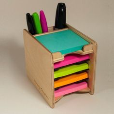 a multicolored pen holder holds several pens and magnets, including one for markers