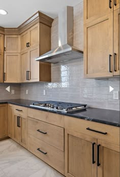 a kitchen with wooden cabinets and black counter tops