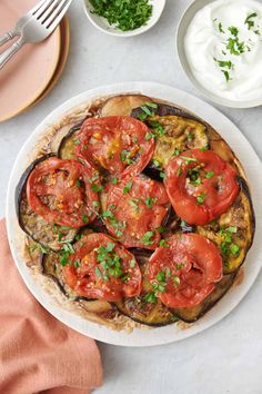 an eggplant dish with tomatoes and sour cream