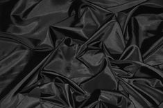 black satin fabric textured with folds