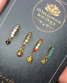 three pairs of jeweled ear clips in a box