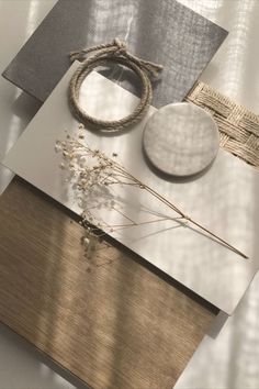 an assortment of items are displayed on a table with silver and gold accents, including a round object