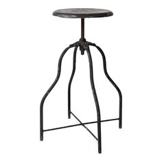 an iron stool with a wooden seat