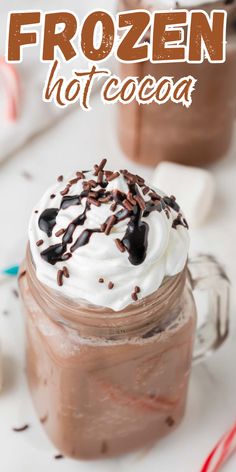 there is a chocolate drink with whipped cream and sprinkles on top in a mason jar