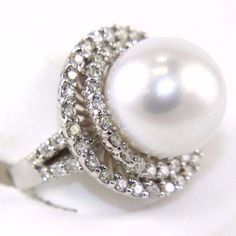 a white pearl and diamond ring on a white background with clippings to the side