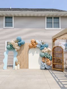 a large balloon arch on the side of a house