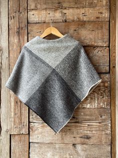 Grey wool poncho large check Lambswool ladies poncho cape Pure wool blanket poncho in check Grey lambswool ponchos Wool poncho cape checked One size fits fashionably for most everyone, short or tall, big or small. This piece is versatile for both Men's & Women's outdoor fashion, and can be used insider in cooler winter weather to keep warm while reading on the couch. CARE: Hand-wash and hang to dry, light iron if needed, or dry clean. MEASURES: Length at the front of the neckline to the bottom i Casual Wool Poncho One Size, Casual Oversized Gray Poncho, Cozy Long Sleeve Wool Poncho, One-size Gray Poncho For Layering, Womens Outdoor Fashion, Luxury Wool Poncho, One Size, Blanket Poncho, Wool Poncho, Ladies Poncho