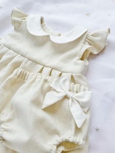 Cotton Bubble Romper With Short Sleeves For Baptism, Fitted Cream Bubble Romper With Ruffles, Cream Fitted Bubble Romper With Ruffles, Cute Beige Cotton Bubble Romper, Cream Ruffled Bubble Romper For Baptism, Cream Bubble Romper With Ruffles For Baptism, Cute Cream Bubble Romper With Ruffles, Cream Sleeveless Bubble Romper With Ruffles, Cream Cotton Bubble Romper With Short Sleeves