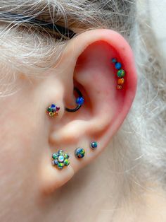 a close up of a person with some piercings on their ears and behind the ear