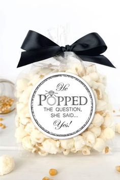 a bag filled with white popcorn sitting on top of a table