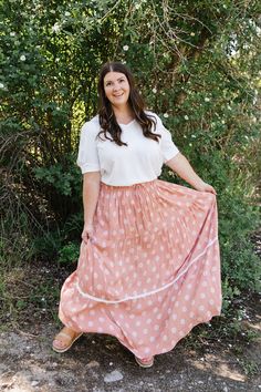 ALL SALES FINAL NOT ELIGIBLE FOR RETURN Unleash your inner beauty with the Delaney Maxi Skirt. The muted peach hue, geometric floral design, and lace accents create a dreamy, effortless look. With a tiered silhouette and an elastic waist with a faux tie, this skirt offers everything in one. Fits true to size. Model is wearing a large and is 5'5". Plus model is wearing a 1X and is 5'6". Size Chart Length Waist S 39.5" 24" M 39.5" 26" L 39.5" 28" 1x 41" 30" 2x 41" 32" 3x 41" 34" *Measurements are Spring Maxi Skirt With Lace Trim And Relaxed Fit, Pink Tiered Bohemian Bottoms, Beige Bottoms With Lace Trim Flowy Design, Spring Peach Flowy Skirt, Feminine Peach Skirt For Spring, Flowy Lace Trim Maxi Skirt For Spring, Spring Peach Long Skirt, Bohemian Tiered Skirt With Lace Trim, Spring Tiered Maxi Skirt With Lace Trim