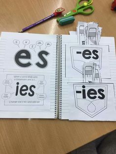 an open notebook with the words ess and ies written in black on it