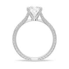 a white gold engagement ring with a heart shaped diamond in the center and filigrees on the sides