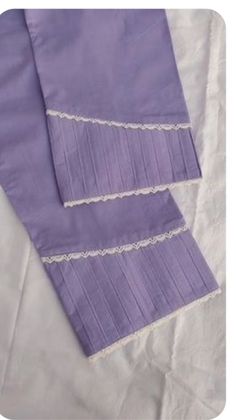 two purple napkins with white lace on them