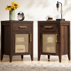 two wooden side tables with wicker doors and handles, one has a clock on top