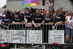 a group of people standing behind a barricade