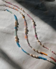 These coastal collection necklaces come in pink, multi sunset, and blue :) Perfect for summer and the beach! 20% of profits made will be donated to local women's health organizations. Coastal Grandma Jewelry, Cute Beachy Jewelry, Trendy Pink Jewelry For Beach Season, Beaded Beach Jewelry, Pink Beaded Necklace For Summer Gifts, Handmade Beaded Necklaces For Summer Gifts, Summer Strand Jewelry With Letter Beads, Handmade Summer Beaded Necklaces For Gifts, Handmade Beaded Summer Necklaces As Gift