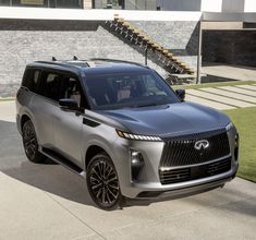 the new infiniti concept suv is shown parked on a sidewalk next to some steps