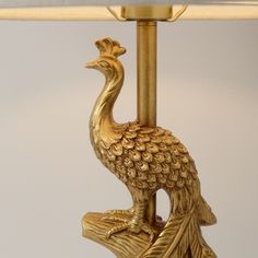 a lamp with a gold peacock on it