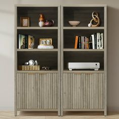 an empty bookcase with books and other items on it