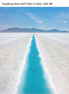 a long stretch of blue water in the middle of nowhere, with mountains in the background