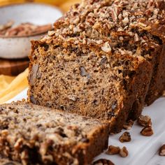 sliced loaf of banana nut bread on a white plate