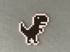 a black and white pixelated dinosaur on a gray background