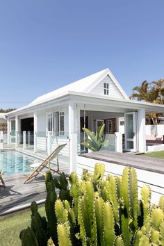 a white house with a pool in the background