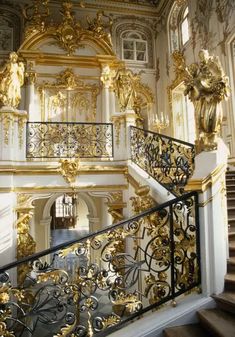 an ornate staircase with gold and white decorations