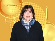 a woman standing in front of a yellow background with pots and pans on it